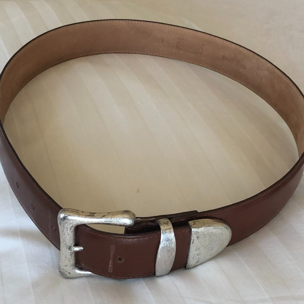 Harken USA made full leather belt; metal buckle pieces made in Spain.